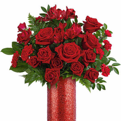 Tall arrangement of red roses and red accent flowers in a sparkling red cylinder vase