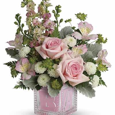 Pink roses and white mums in a pink baby block glass cube vase