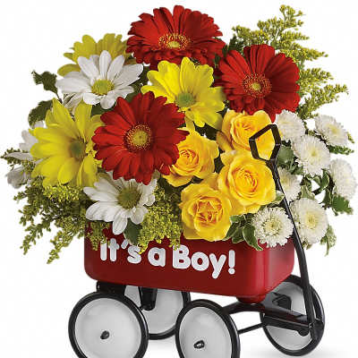 Bright mixed arrangement of red gerberas, yellow roses, and white daisies in a red 'It’s a Boy!' toy wagon
