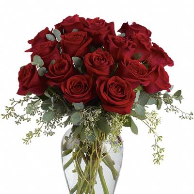Arrangement of long-stem red roses in a clear glass vase