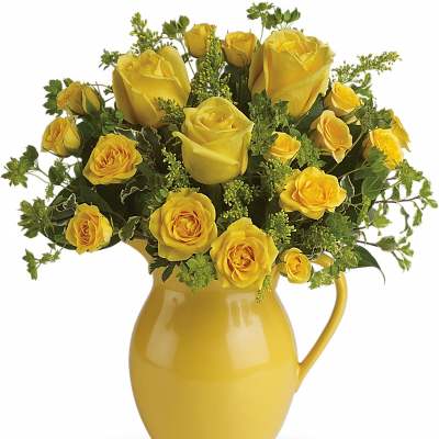Medium bouquet of yellow roses in a glossy yellow ceramic pitcher