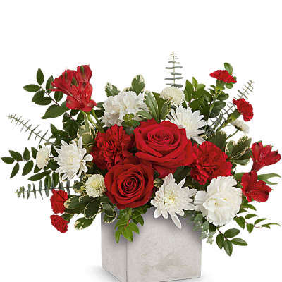 Red roses with white carnations and mums in a square ceramic vase