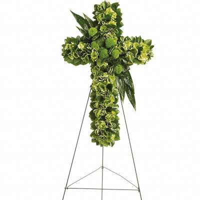 Standing cross of green flowers on a metal easel