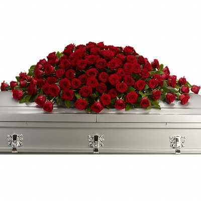 Large casket spray of red roses arranged across a closed silver casket
