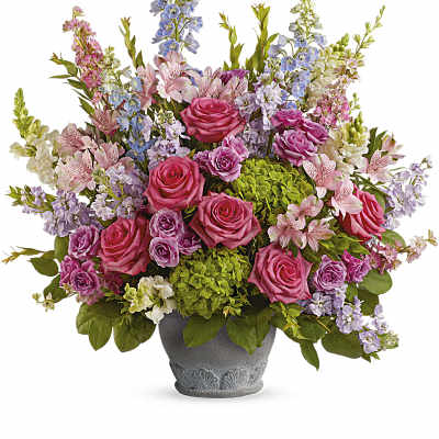 Tall pink rose and mixed flower arrangement with green hydrangeas in a gray footed pot