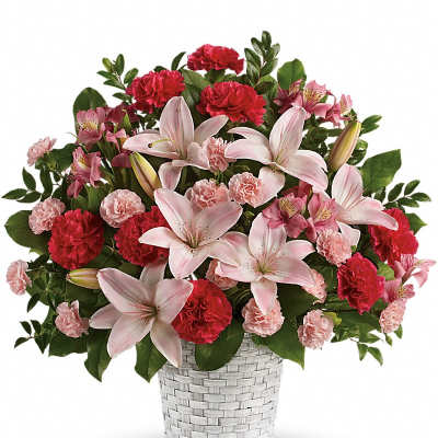 Basket arrangement of pink lilies, red and light pink carnations, and alstroemeria in a white woven container