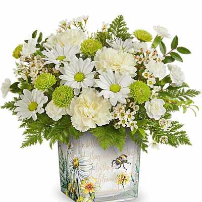 White daisies and carnations with green mums in a square glass vase with floral bee design.