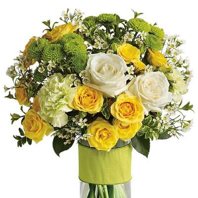 Mixed bouquet of yellow and white flowers in a clear glass vase wrapped with a green band