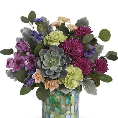 Mixed purple and green flower arrangement with succulent in a green mosaic cylinder vase