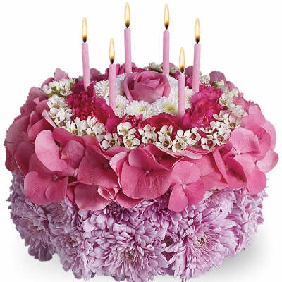 Round pink floral cake arrangement with candles made of roses, hydrangeas, and mums.