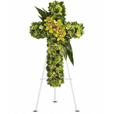 Tall green floral cross with yellow orchids on a white easel stand