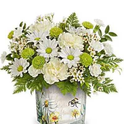 White daisies and green pom flowers in a painted glass vase