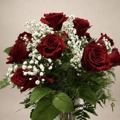 Red roses and white baby's breath in a clear glass vase