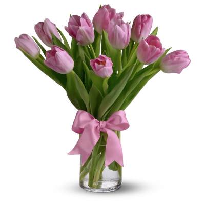 Tall bouquet of pink tulips in a clear glass vase with a pink ribbon bow
