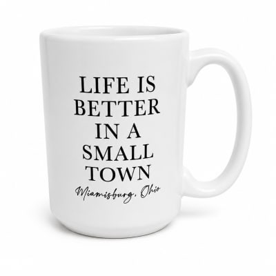 White mug with black text reading "Life is better in a small town"