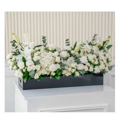 White floral arrangement in a black rectangular box