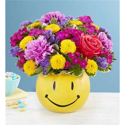 Colorful mixed bouquet in a yellow smiley-face container