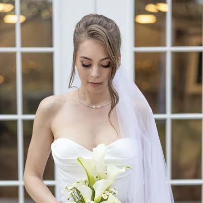Bride holding a bouquet of white calla lilies