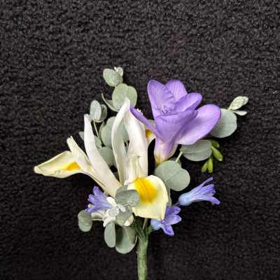 Small boutonniere with purple and white flowers and eucalyptus