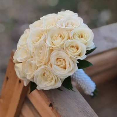 White rose bridal bouquet with a small wrapped handle