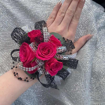 Pink rose wrist corsage with black and silver ribbon accents