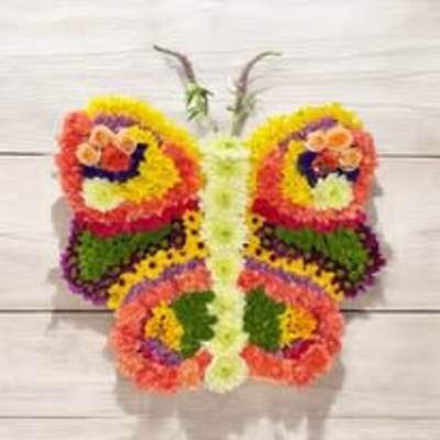 Butterfly-shaped floral arrangement with bright multicolored blooms