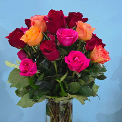 Mixed roses in a clear glass vase with a gold base