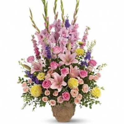 Tall mixed flower arrangement in a woven basket
