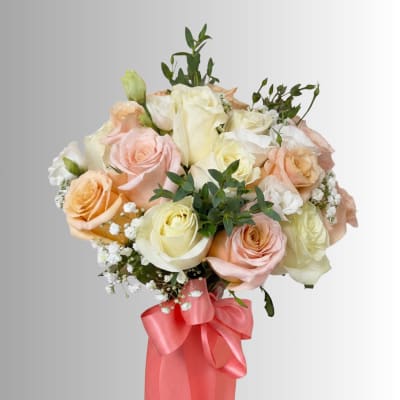 Bouquet of pastel roses with baby’s breath and a pink ribbon