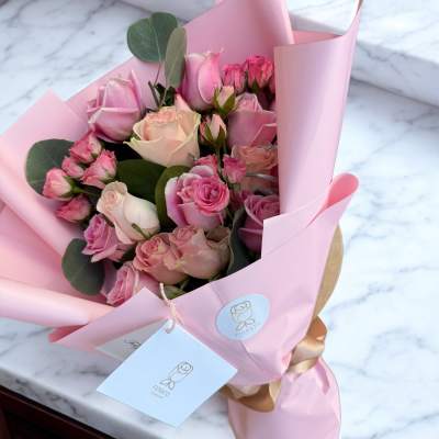 Pink rose bouquet wrapped in pastel paper
