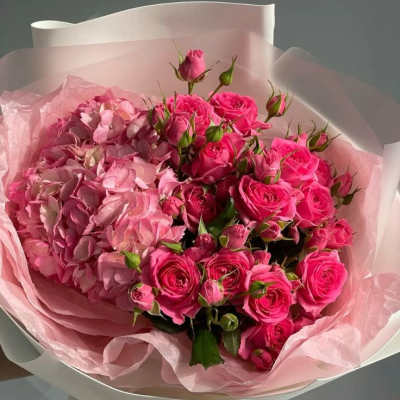 Pink rose and hydrangea bouquet wrapped in pale pink paper