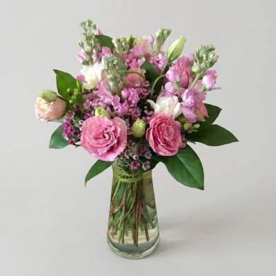 Pink and white bouquet in a clear glass vase