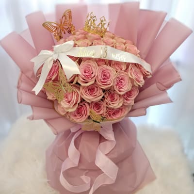 Pink rose bouquet with a crown and butterfly decorations