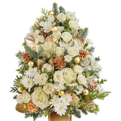 White roses and daisies arranged in a gold vase with pinecones and ornaments