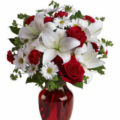 Red roses and white lilies in a red glass vase