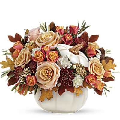 Autumn floral arrangement in a white pumpkin vase with roses and calla lilies