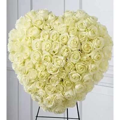 Heart-shaped arrangement of ivory roses on a standing easel