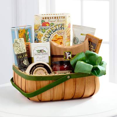 Gift basket with assorted packaged snacks and a green ribbon bow