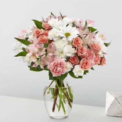 Pink and white mixed bouquet in a clear glass vase