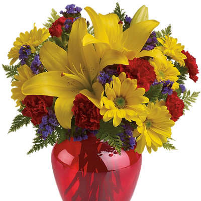 Yellow lilies and daisies in a red glass vase