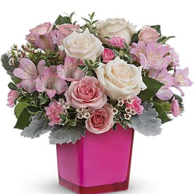 Pink and white roses with pink alstroemeria in a bright pink vase