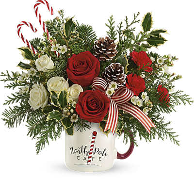 Christmas bouquet in a mug with red and white roses and candy canes