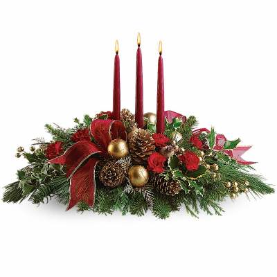 Holiday centerpiece with three red candles, pinecones, and red flowers