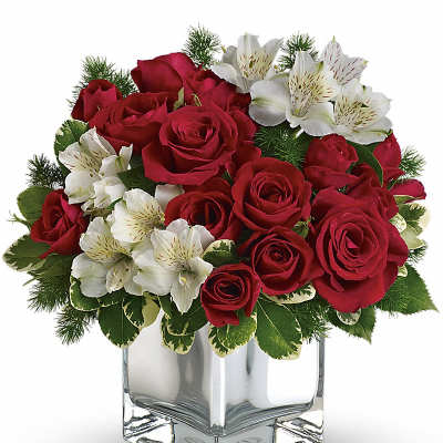 Red roses and white alstroemeria in a clear square vase