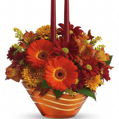 Autumn floral centerpiece with two burgundy taper candles in a copper bowl