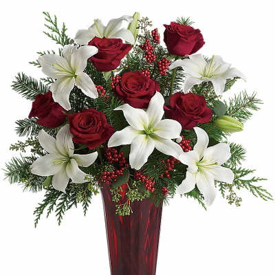 Red roses and white lilies arranged in a tall red vase