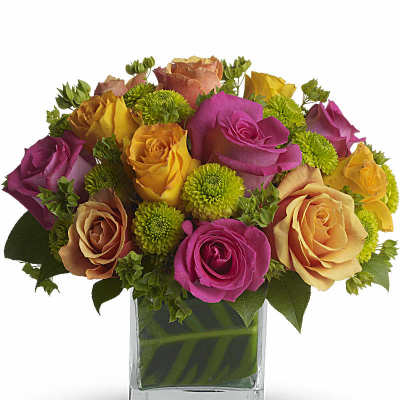 Bouquet of multicolored roses in a clear glass vase