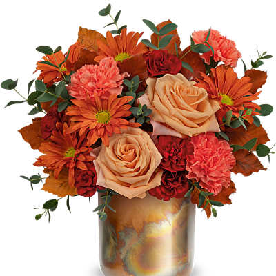 Bouquet of orange, peach, and red flowers in a metallic vase