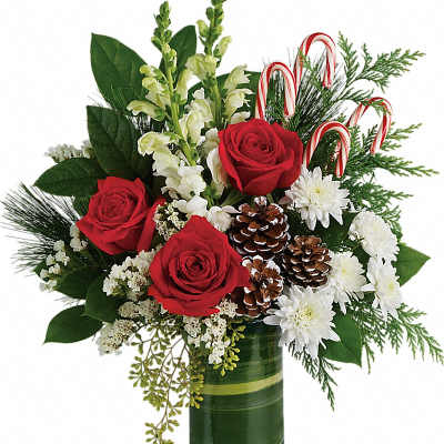 Red roses and white flowers in a green glass vase with candy canes and pinecones
