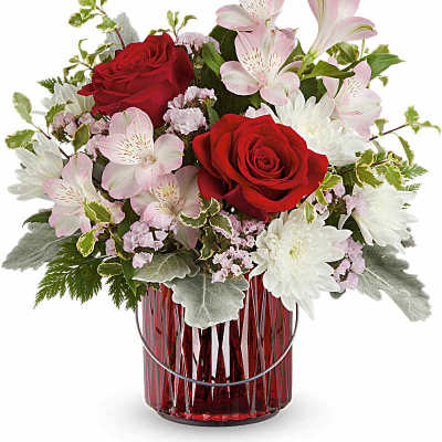 Red roses and pink lilies in a red glass vase